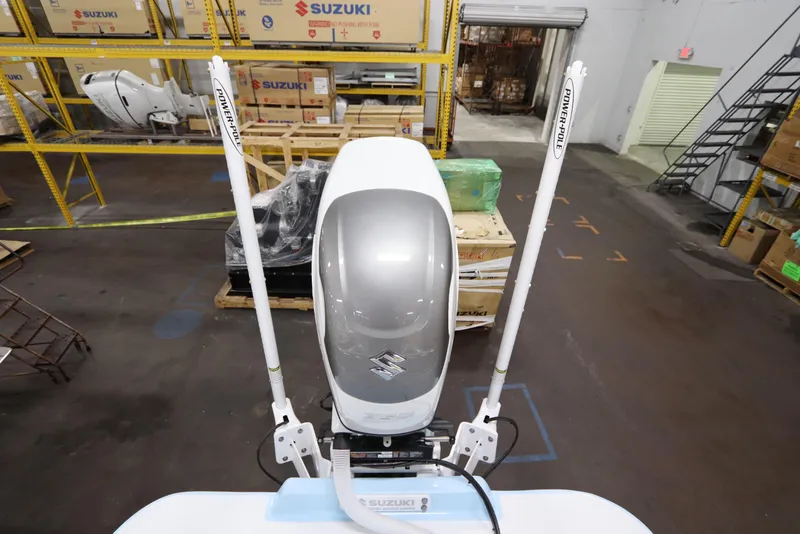 Slide: The Image of 2024 SeaCraft 23CC boat with Suzuki outboard engine in warehouse setting. - 20