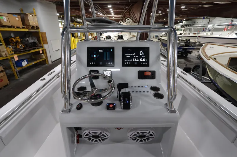 Slide: The Image of 2024 SeaCraft 23CC boat console with modern controls and digital displays in a showroom. - 28