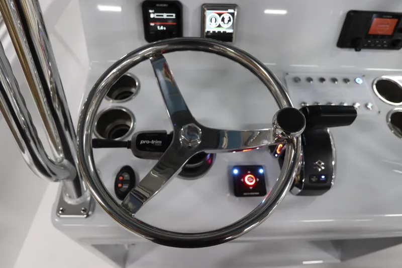 Slide: The Image of 2024 SeaCraft 23CC boat dashboard with steering wheel and control panel. - 31