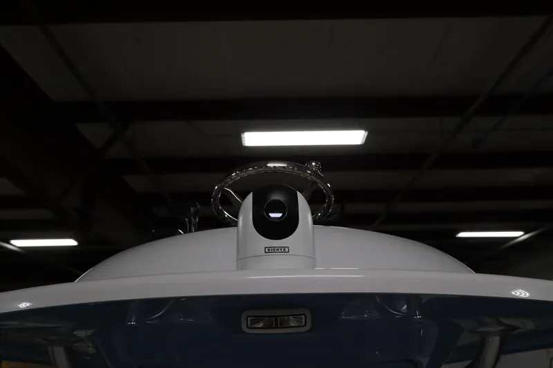 Slide: The Image of 2024 SeaCraft 23CC boat helm with advanced navigation equipment in a dimly lit setting. - 38