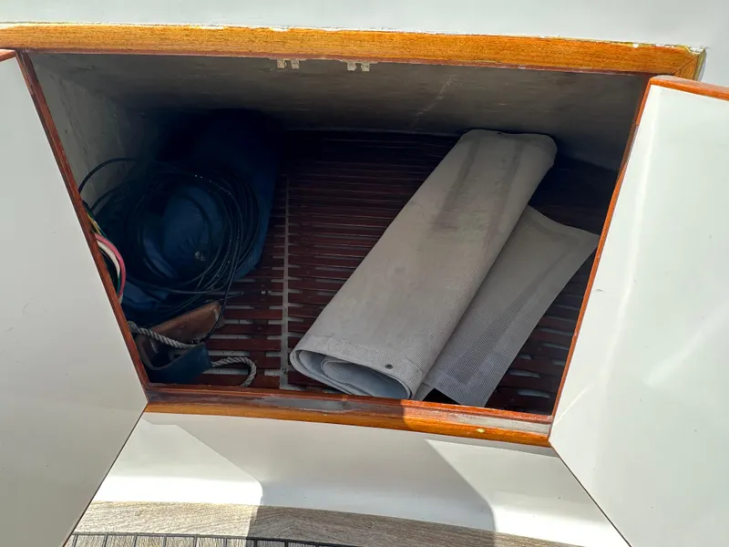 Slide: The Image of Storage compartment on 1985 Ocean Alexander Pilothouse yacht with coiled cables and rolled fabric. - 12