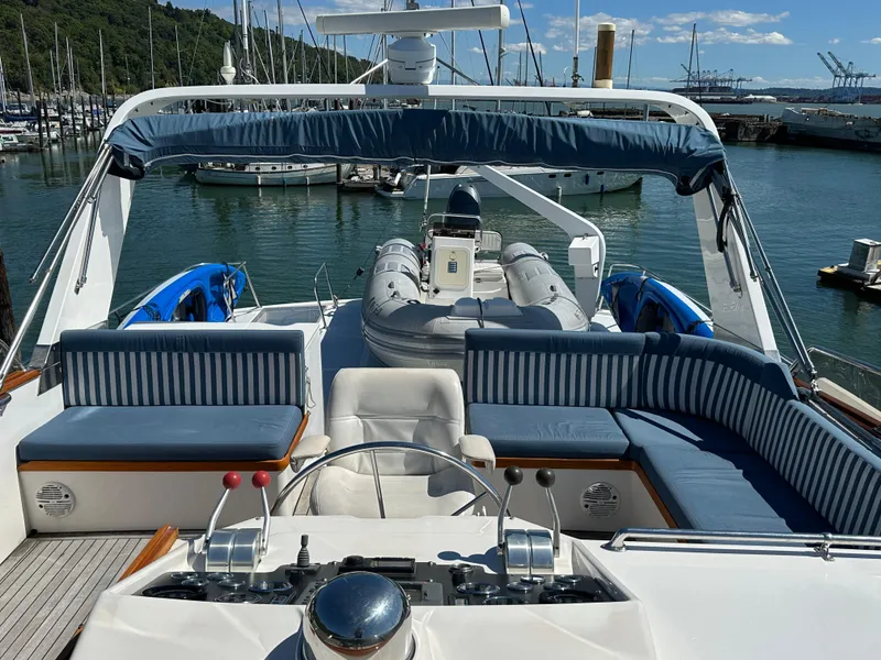 Slide: The Image of 1985 Ocean Alexander Pilothouse yacht with spacious deck and seating, docked in a marina. - 18