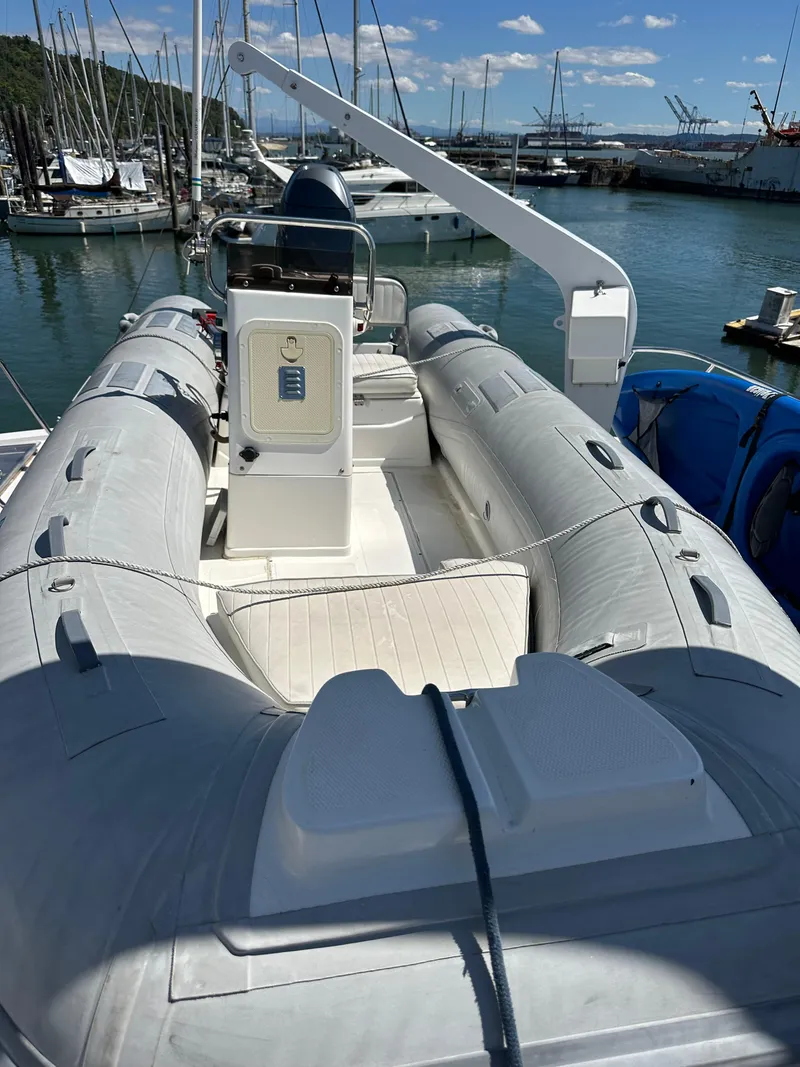 Slide: The Image of Inflatable boat on Ocean Alexander Pilothouse 1985, docked in marina under clear sky. - 22