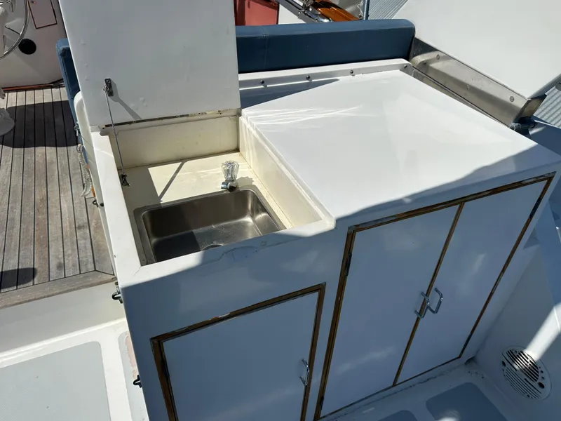Slide: The Image of 1985 Ocean Alexander Pilothouse yacht sink and storage area on deck. - 25
