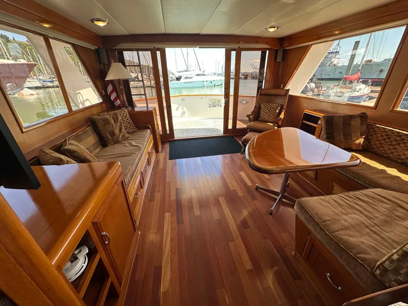 Slide: The Image of Luxurious interior of 1985 Ocean Alexander Pilothouse yacht with wood flooring and plush seating. - 39