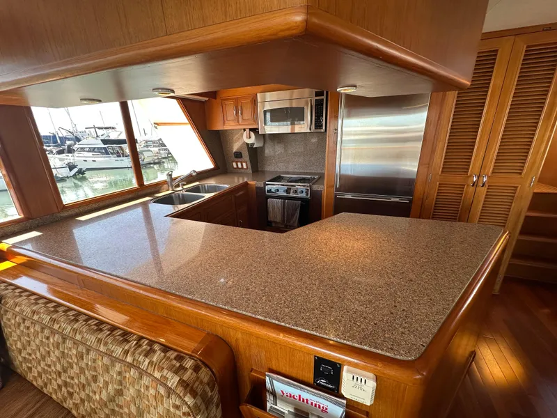 Slide: The Image of Luxurious kitchen interior of 1985 Ocean Alexander Pilothouse yacht with modern appliances. - 46