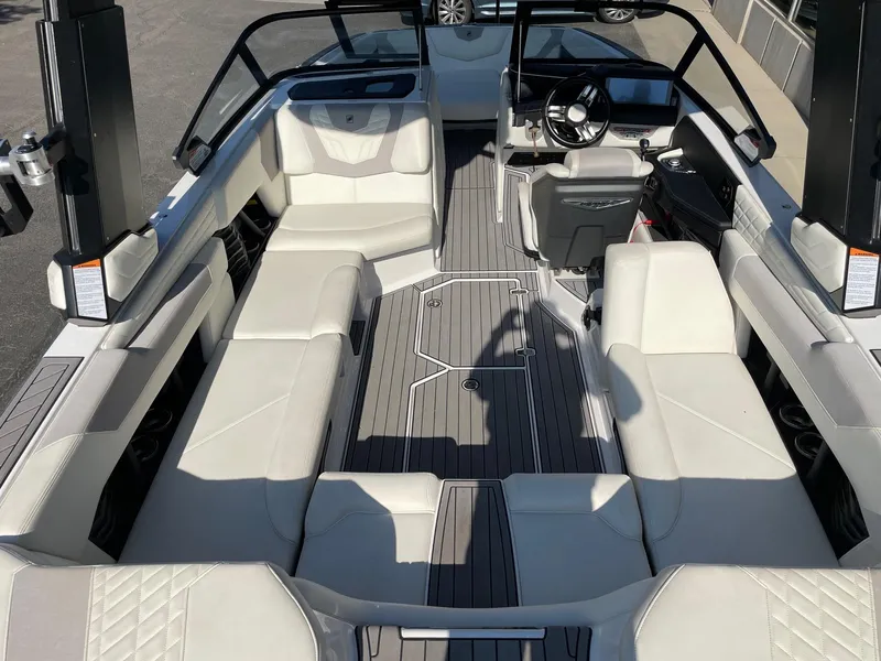 Slide: The Image of 2022 Nautique Super Air G23 boat interior with white seating and sleek design. - 5