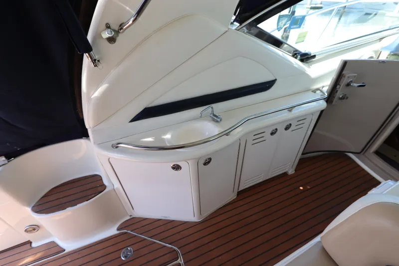 Slide: The Image of 2004 Sea Ray 420 Sundancer interior with wooden flooring and sleek cabinetry. - 17