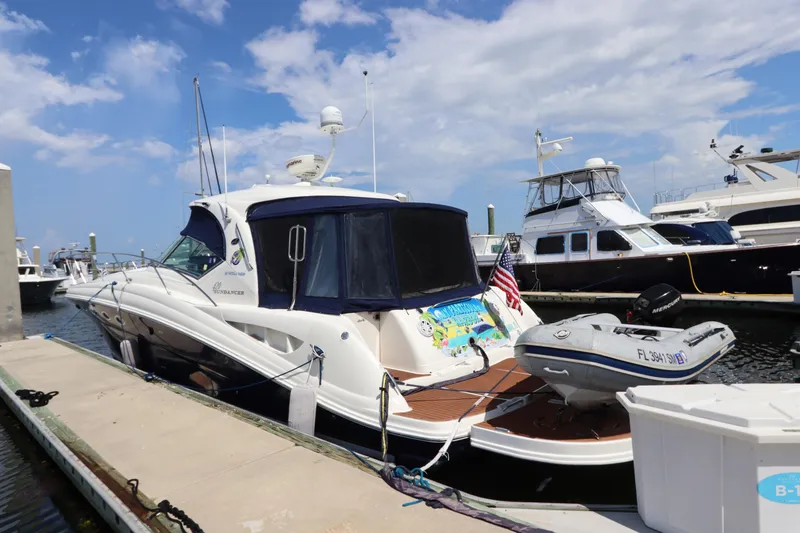 Slide: The Image of 2004 Sea Ray 420 Sundancer yacht docked at marina under blue sky. - 2