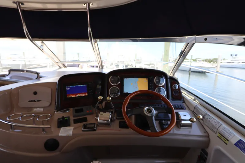 Slide: The Image of Helm of 2004 Sea Ray 420 Sundancer with navigation screens and controls. - 22