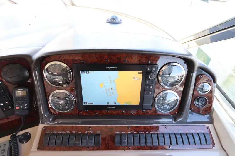 Slide: The Image of Dashboard of 2004 Sea Ray 420 Sundancer with navigation system and gauges. - 24