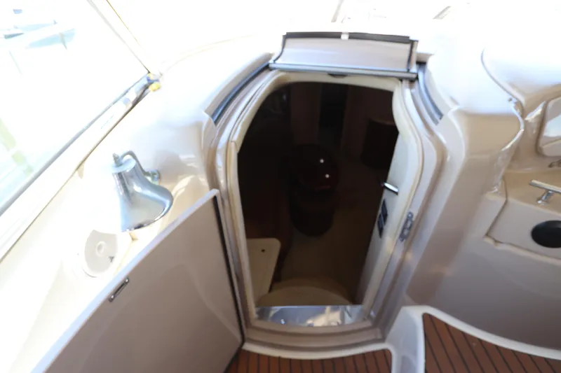 Slide: The Image of 2004 Sea Ray 420 Sundancer cabin entrance with open door and interior view. - 25
