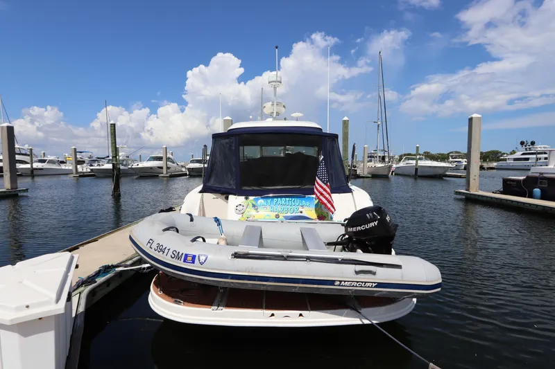 Slide: The Image of 2004 Sea Ray 420 Sundancer docked with inflatable boat and American flag. - 3