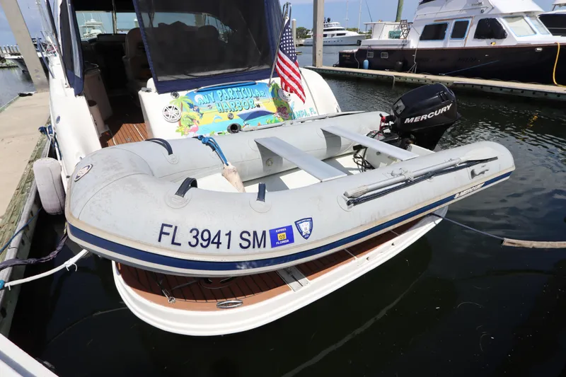 Slide: The Image of 2004 Sea Ray 420 Sundancer with inflatable boat and Mercury motor at marina. - 4