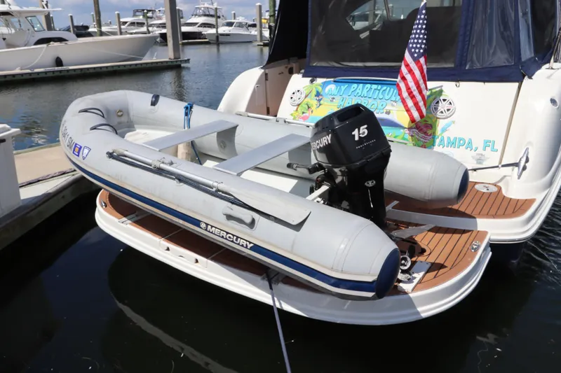 Slide: The Image of 2004 Sea Ray 420 Sundancer with inflatable Mercury boat docked in marina. - 5