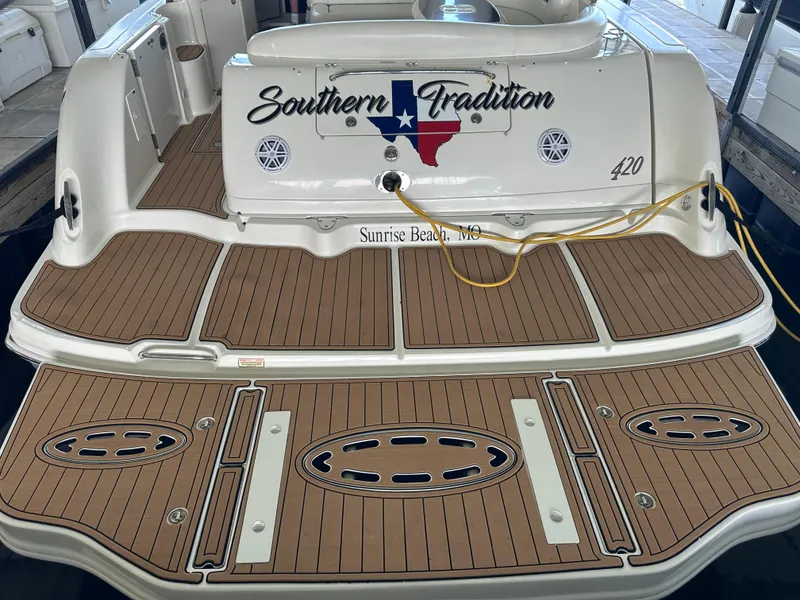 Slide: The Image of 2005 Sea Ray 420 Sundancer boat with custom deck and "Southern Tradition" branding. - 11