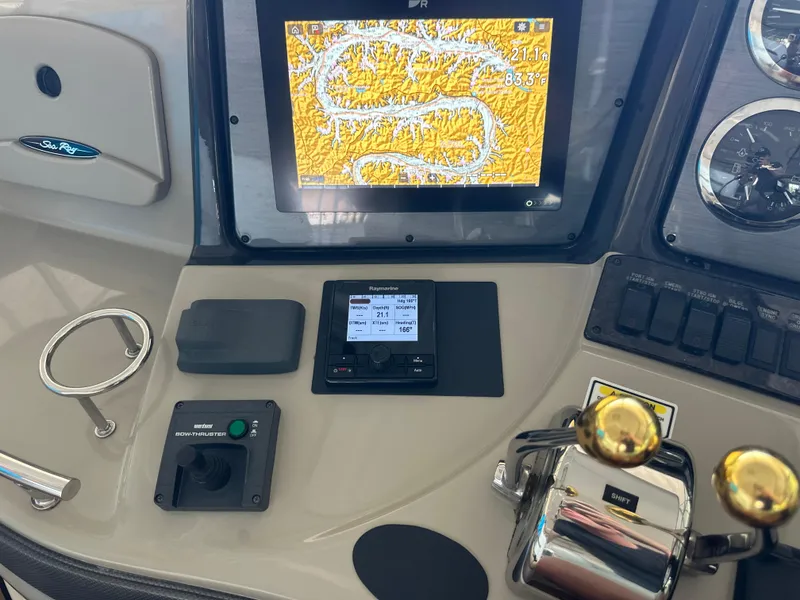 Slide: The Image of Control panel of a 2005 Sea Ray 420 Sundancer with navigation and throttle controls. - 17