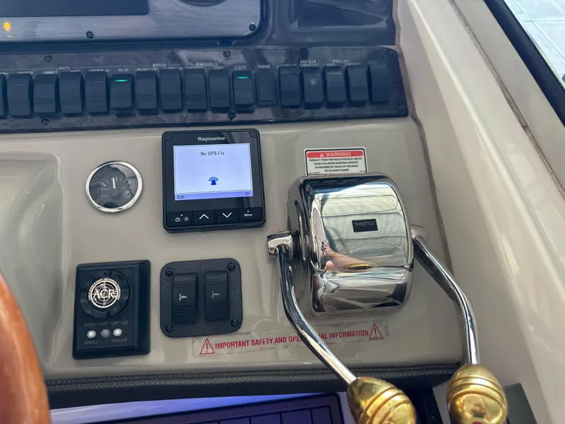Slide: The Image of Control panel of a 2005 Sea Ray 420 Sundancer with throttle and GPS display. - 18