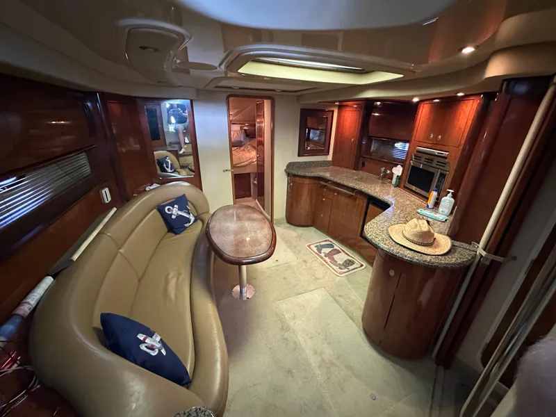 Slide: The Image of Luxurious interior of 2005 Sea Ray 420 Sundancer yacht with elegant seating and kitchen area. - 29
