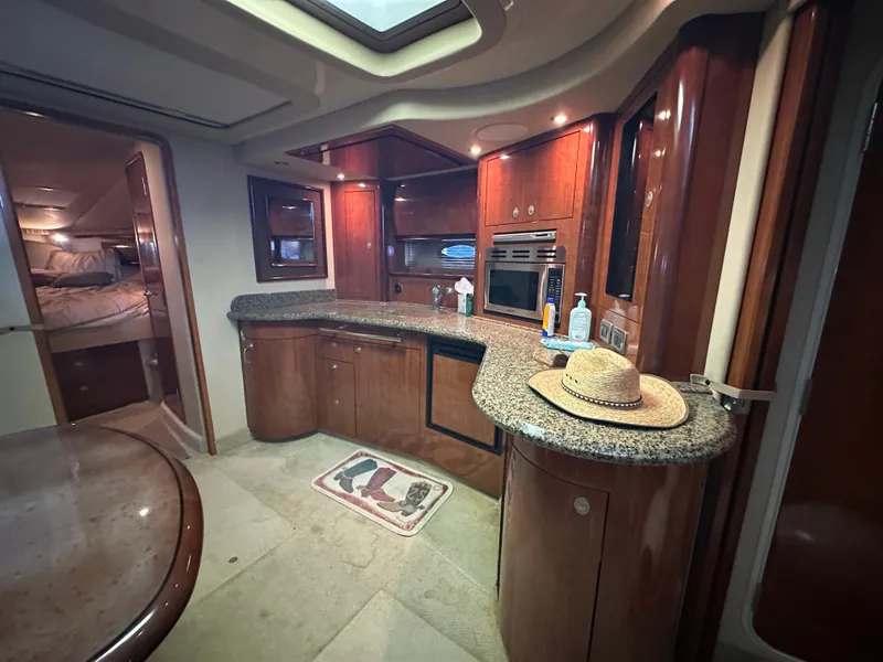 Slide: The Image of Luxurious 2005 Sea Ray 420 Sundancer yacht interior with modern kitchen and cozy cabin. - 30