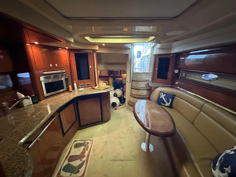 Slide: The Image of Luxurious interior of 2005 Sea Ray 420 Sundancer yacht with kitchen and seating area. - 31