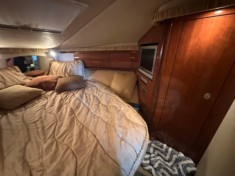 Slide: The Image of Luxurious cabin interior of 2005 Sea Ray 420 Sundancer with cozy bedding and wood paneling. - 37