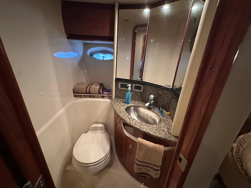 Slide: The Image of Luxurious bathroom in 2005 Sea Ray 420 Sundancer yacht with granite countertop and porthole window. - 38