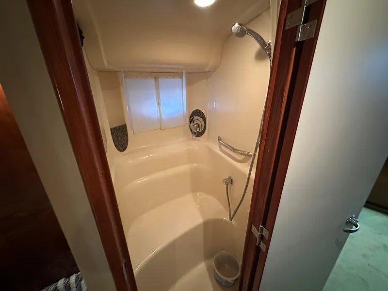 Slide: The Image of 2005 Sea Ray 420 Sundancer bathroom with shower, featuring sleek design and modern fixtures. - 39