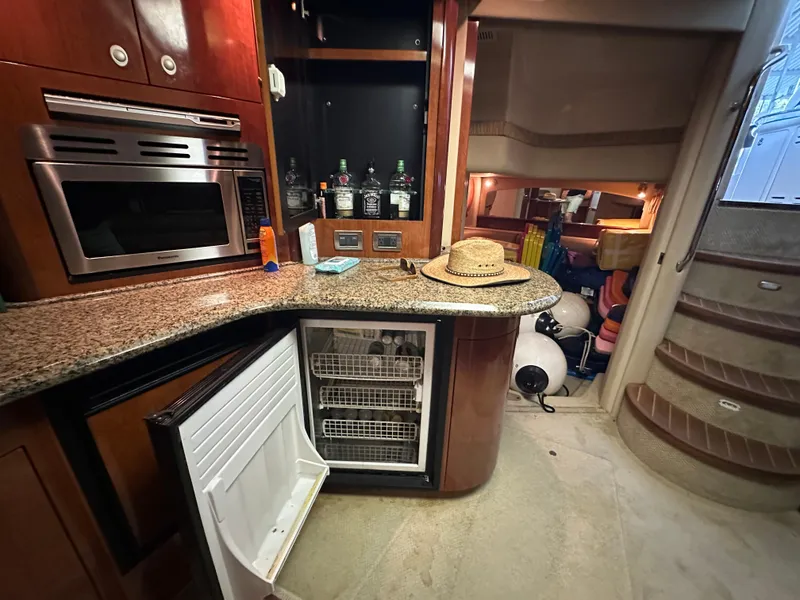 Slide: The Image of Interior of 2005 Sea Ray 420 Sundancer yacht with kitchen and open fridge. - 41