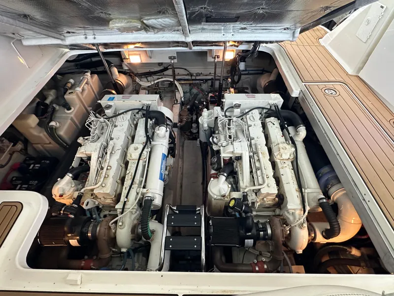 Slide: The Image of Engine room of a 2005 Sea Ray 420 Sundancer, showcasing dual marine engines. - 47
