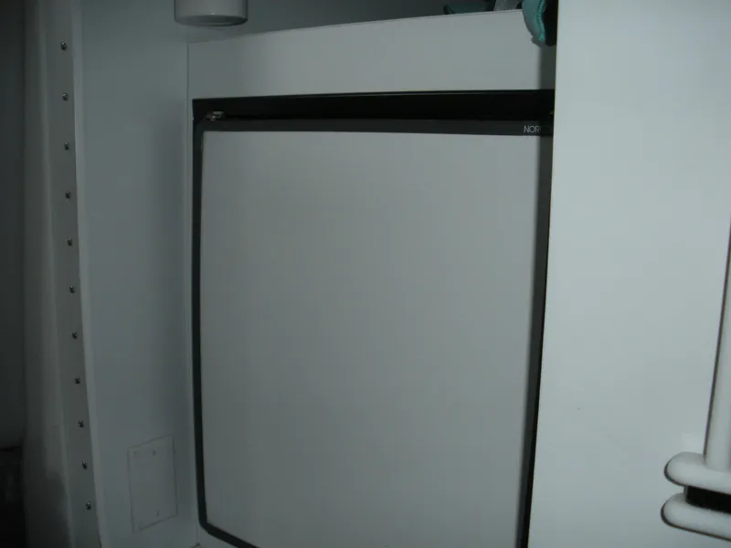 Slide: The Image of White refrigerator inside a 2001 Fountain 35 Fastech boat cabin. - 5