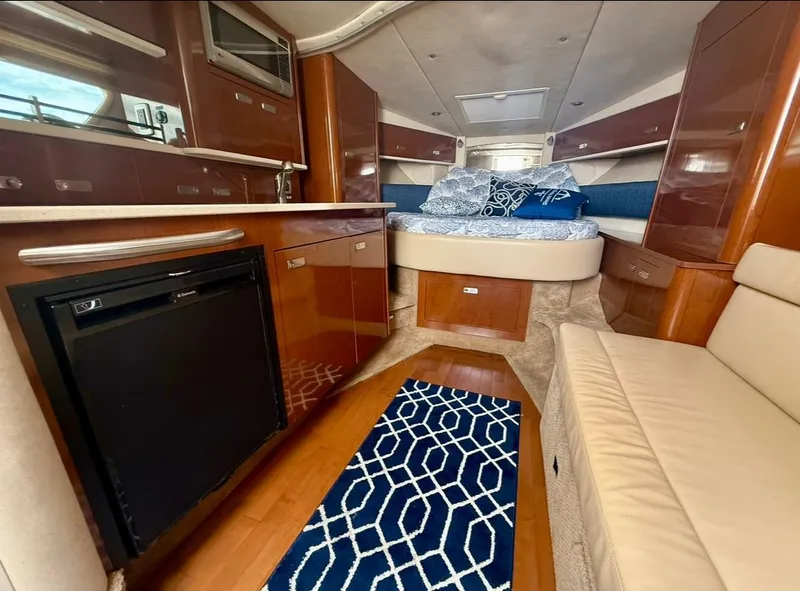 Slide: The Image of Luxurious interior of 2011 Sea Ray 350 Sundancer yacht with modern amenities and cozy sleeping area. - 16