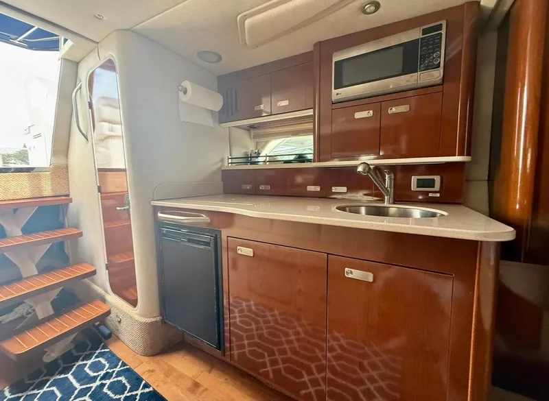 Slide: The Image of Interior of 2011 Sea Ray 350 Sundancer yacht with kitchenette and stairs. - 18