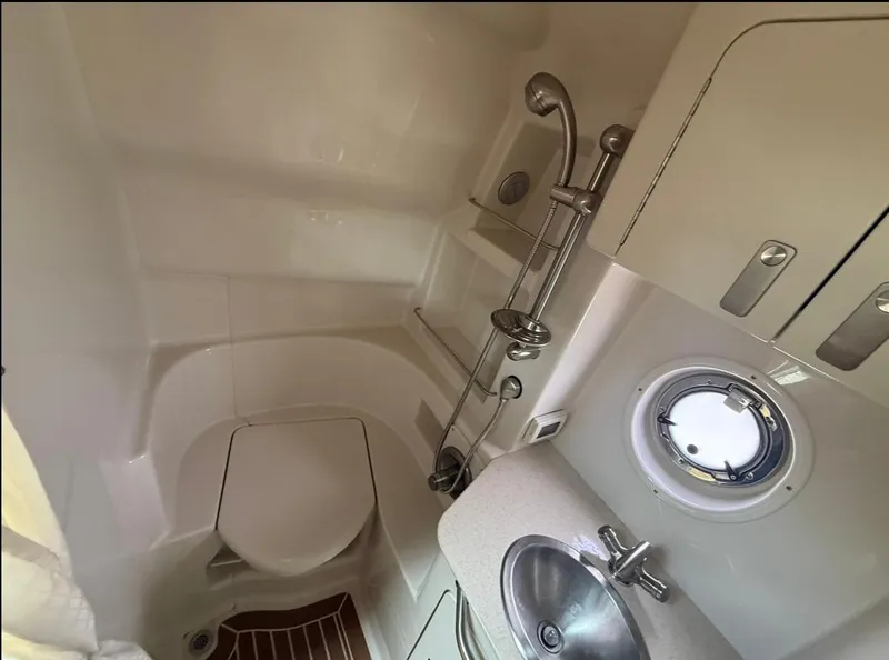 Slide: The Image of Compact bathroom in 2011 Sea Ray 350 Sundancer yacht with shower, sink, and porthole. - 21