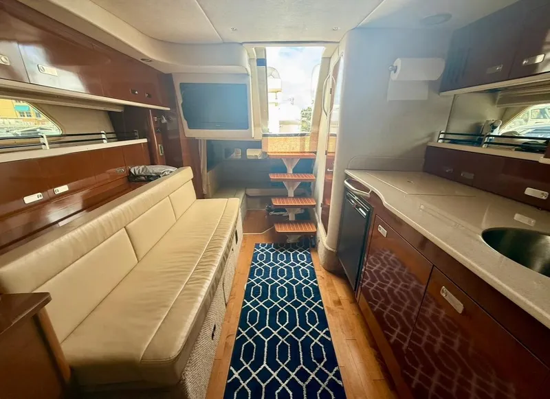 Slide: The Image of Luxurious interior of 2011 Sea Ray 350 Sundancer yacht with modern kitchen and seating area. - 22