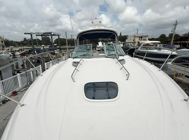 Slide: The Image of 2011 Sea Ray 350 Sundancer yacht docked at marina under cloudy sky. - 23