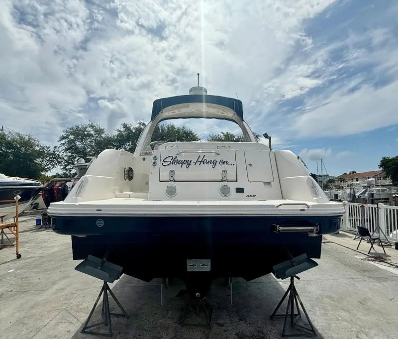 Slide: The Image of 2011 Sea Ray 350 Sundancer boat on dry dock under a partly cloudy sky. - 3