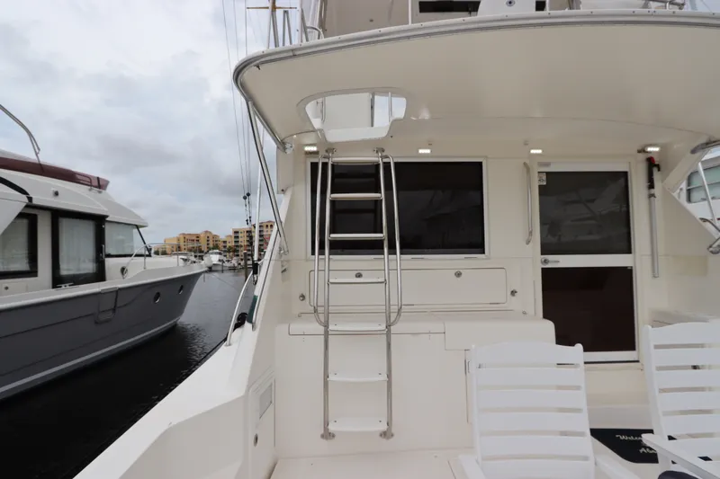 Slide: The Image of The 2001 Riviera 43 Open Flybridge features a spacious aft deck with access to the flybridge. - 13