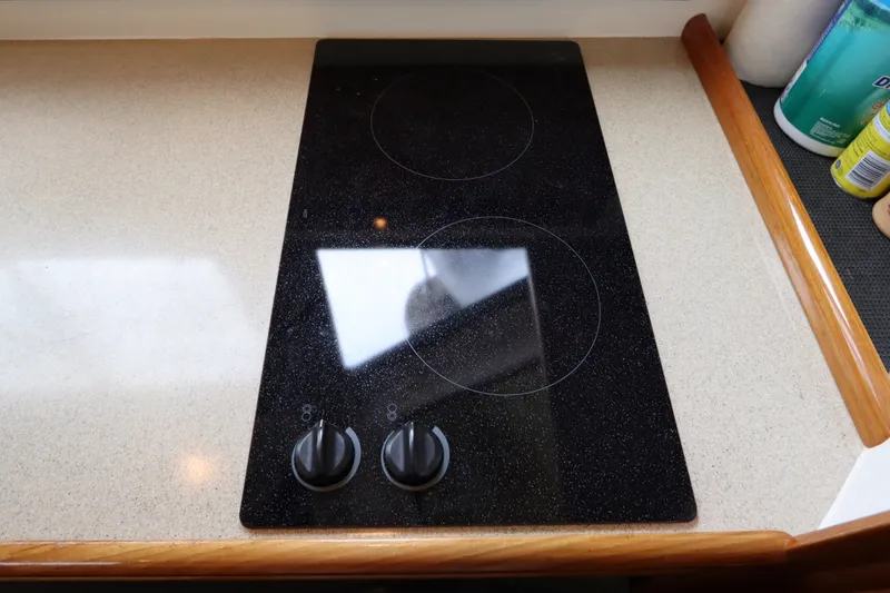 Slide: The Image of A cooktop with two burners and control knobs on a countertop. - 42
