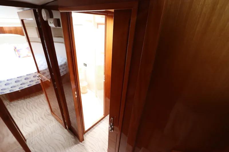 Slide: The Image of Interior of a 2001 Riviera 43 Open Flybridge with wooden doors and carpeted flooring. - 48