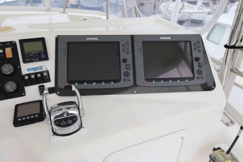 Slide: The Image of The image shows the helm of a 2001 Riviera 43 Open Flybridge with two large screens. - 26
