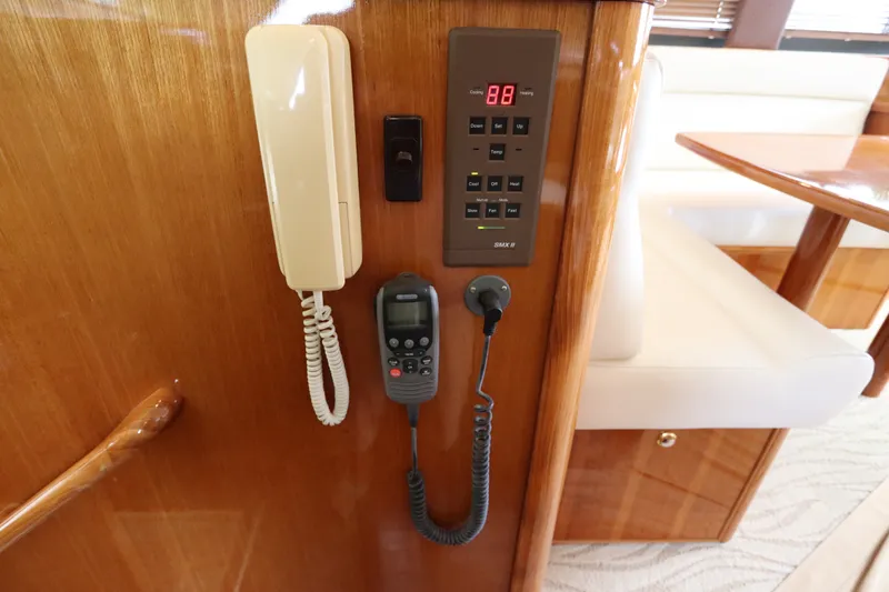 Slide: The Image of The interior view shows a communication panel with a phone and radio on a wooden wall. - 47