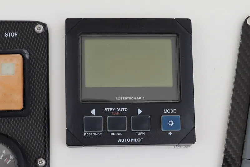 Slide: The Image of A Simrad Robertson AP11 autopilot display is mounted on a boat console. - 27
