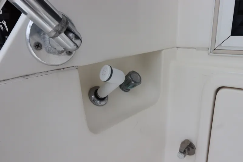 Slide: The Image of Close-up of a boat part with a white and a metallic knob. - 15