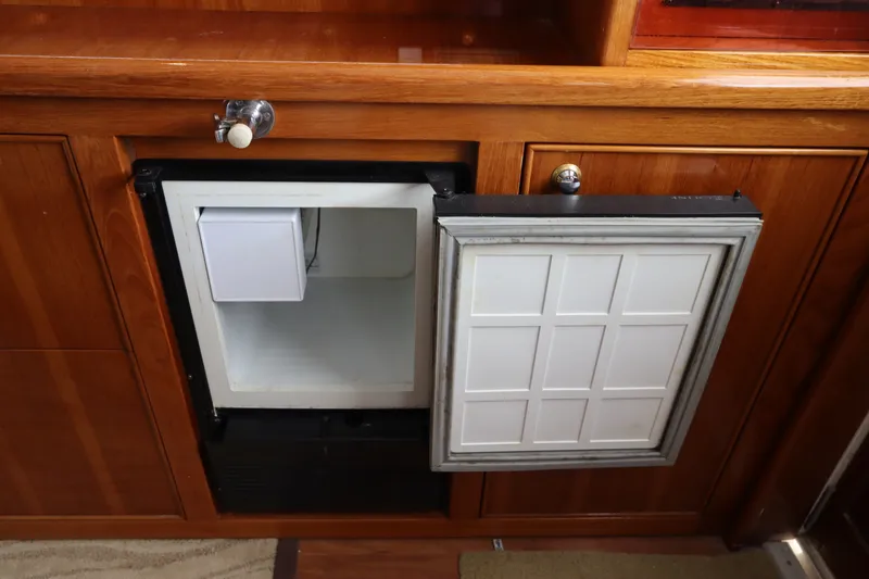Slide: The Image of An open refrigerator in a wooden cabin on a boat. - 35
