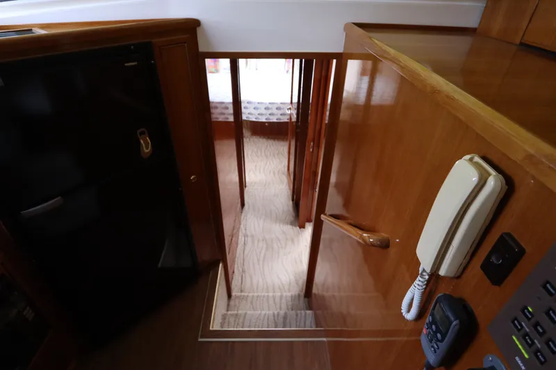 Slide: The Image of Interior view of a 2001 Riviera 43 Open Flybridge with wood paneling and stairs. - 46