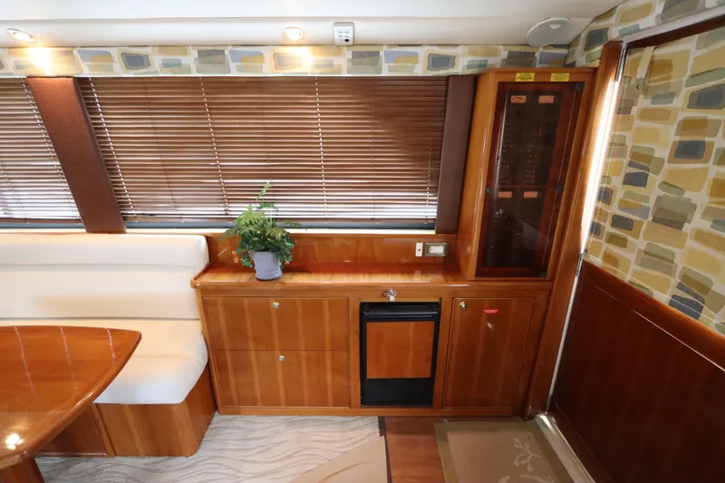Slide: The Image of Interior of a 2001 Riviera 43 Open Flybridge with wooden furnishings and a plant. - 33