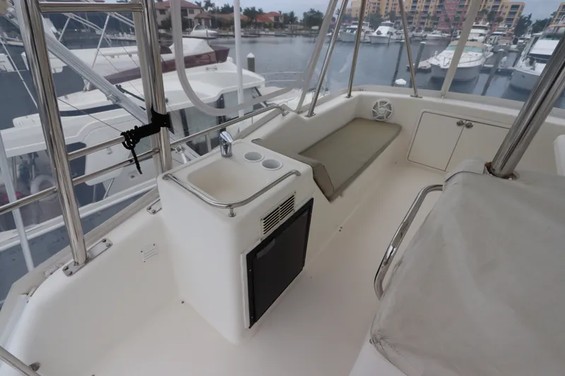 Slide: The Image of The image shows the deck of a 2001 Riviera 43 Open Flybridge with seating and a sink. - 20