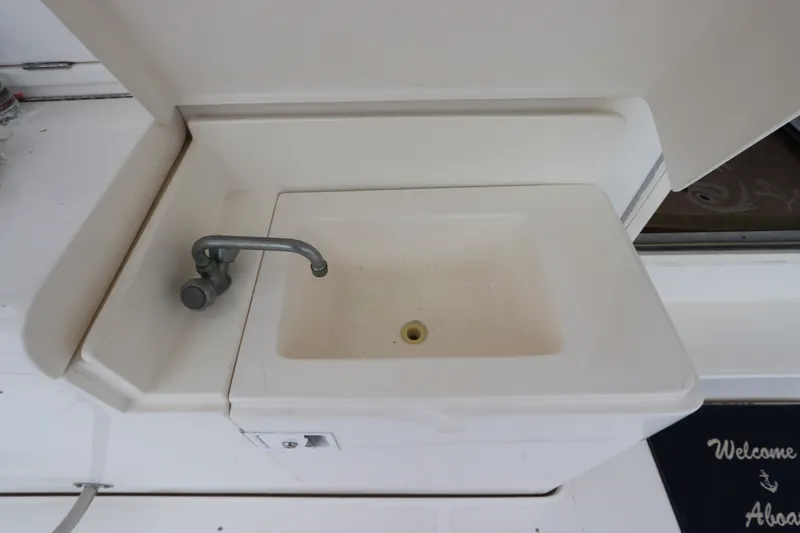 Slide: The Image of A white sink with a faucet on a boat, surrounded by a clean surface. - 17