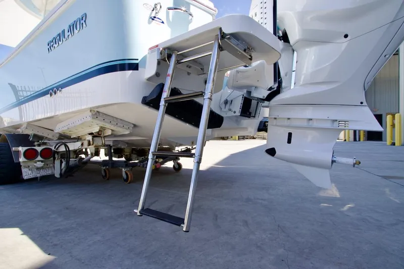 Slide: The Image of 2026 Regulator 26XO boat console with steering wheel and dual screens. - 14